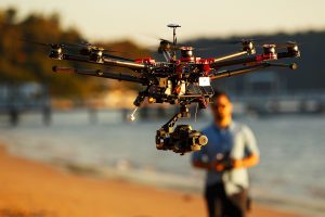 SYDNEY, AUSTRALIA - JULY 04: Drone operator, Ken Butti lands the custom built DJI s1000 Drone at Palm Beach on July 4, 2014 in Sydney, Australia. Commercial and recreational UAV (Unmanned Aerial Vehicles) sales in Australia have regulators concerned about safety, privacy and security, while the commercial industries of mining, farming, property, and sport are embracing the new technology. Under the current CASA (Civil Aviation Safety Authority) regulations all unmanned aircraft weighing more than 2kg need to have a UAS operators certificate. Licensed operators are not allowed to fly above 400ft, not within 5km of an airfield boundary and can't fly within 30 metres of people not involved with the operation. (Photo by Brendon Thorne/Getty Images)